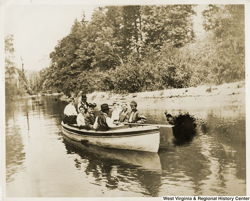 black and white photo of people in a boat