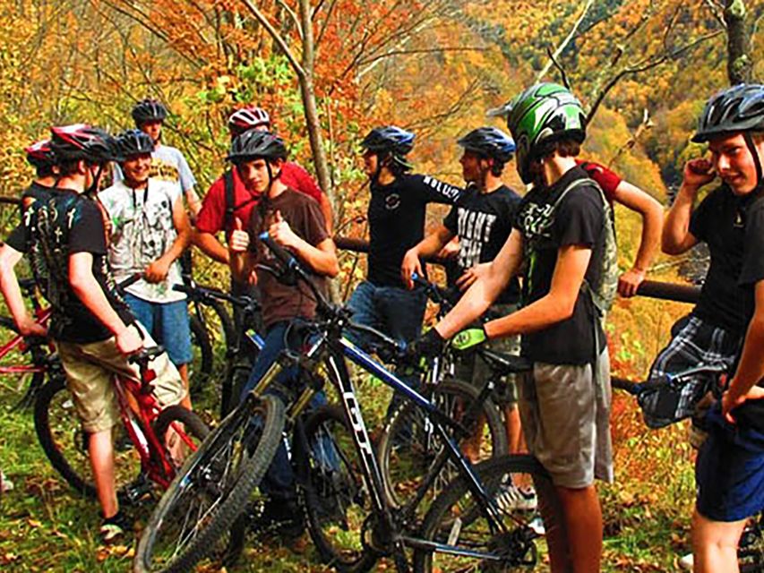 group of mountain bikers standing outside