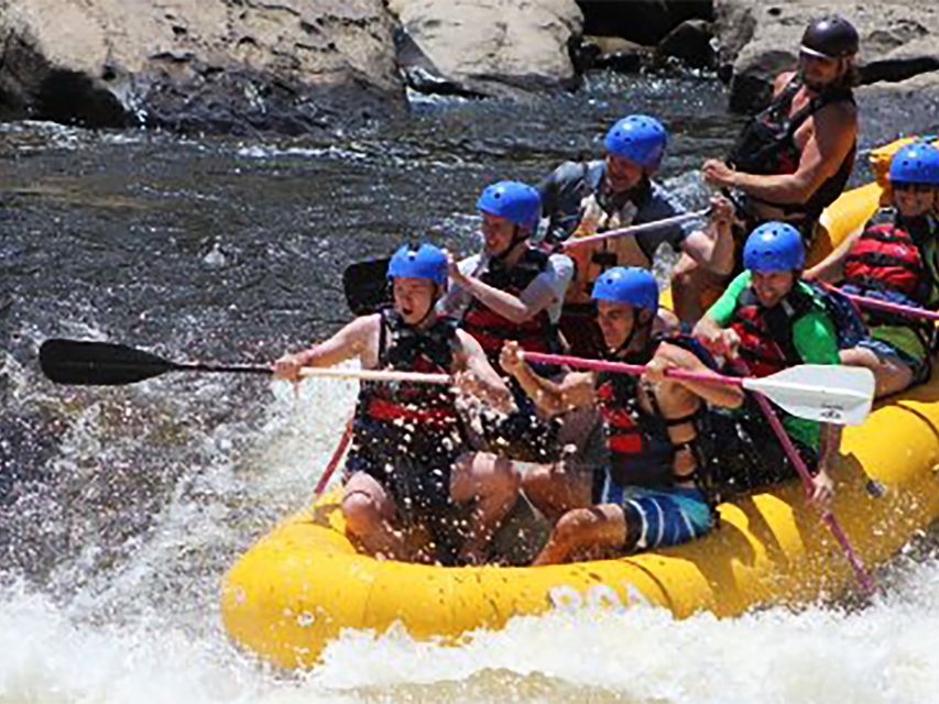 people riding in a raft on a river